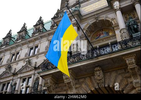 Hamburg, Deutschland. 03. März 2022. Die Flagge der Ukraine fliegt über dem Eingang zum Hamburger Rathaus. Quelle: Jonas Walzberg/dpa/Alamy Live News Stockfoto