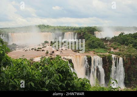 Nahsicht der Aussichtsplattform und Brücken für Touristen der Cataratas Wasser fällt unter blauen Himmel, Regenbogen und einem Wassernebel am Foz do Iguassu pa Stockfoto