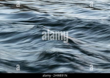 Abstrakte Landschaft aus gewelltem turbulentem Wasser im Wind mit seidiger Oberfläche bei langer Belichtung und Bewegungsunschärfe-Effekt Stockfoto