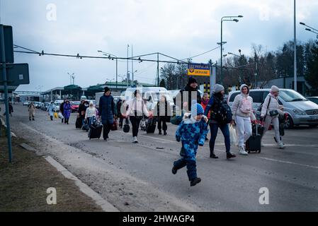 Spanien. 04. März 2022. Ein Junge rennt und springt, während ukrainische Flüchtlinge am 4. März 2022 nach Polen einreisen, einem Grenzübergang zwischen Polen und der Ukraine, während Flüchtlinge aus dem sich verschärfenden Krieg in der Ukraine, ihrem Heimatland, in Medyka, Polen, fliehen. Die Flüchtlingskrise wird sich voraussichtlich noch verschärfen, da der Krieg in der Ukraine eskaliert und mindestens 5 Millionen Menschen in den nächsten Wochen das Land verlassen werden. (Foto von Davide Bonaldo/Sipa USA) Quelle: SIPA USA/Alamy Live News Stockfoto