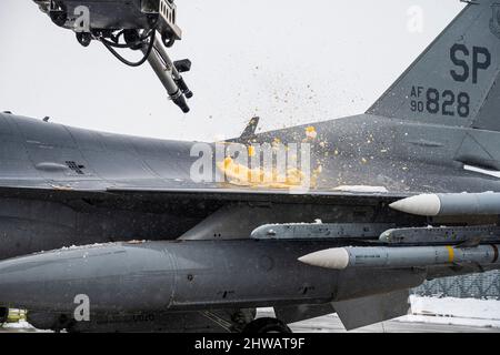 Wartungscrews der US-Luftwaffe, die der 480. Expeditionary Fighter Squadron auf dem Luftwaffenstützpunkt Spangdahlem, Deutschland, zugewiesen sind, verwenden Enteisungsmaschinen, um einen F-16 Fighting Falcon auf der 86. ab, Rumänien, 1. März 2022, zu enteizen. US-Streitkräfte in Europa leben, trainieren und operieren mit Verbündeten und Partnern an strategischen Standorten in ganz Europa, die für eine rechtzeitige und koordinierte Reaktion in Friedenszeiten und Krisen entscheidend sind. (USA Luftwaffe Foto von Senior Airman Ali Stewart) Stockfoto