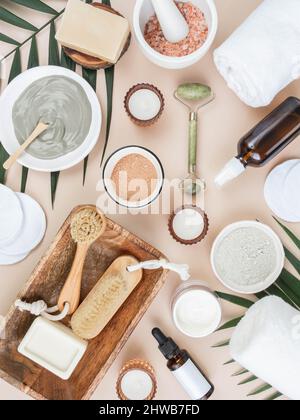 Hausgemachtes Hautpflegekonzept. Biologischer roter und blauer Ton und andere Inhaltsstoffe für die Beauty Gesichtsmaske. Kerzen, Kristallmassager, Pinsel und Handinnenblätter Stockfoto