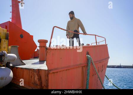 Der Mann mit dem Matrosen im Hafen Stockfoto