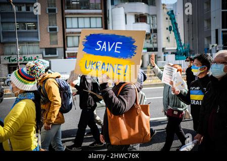 Ein Protestler hält ein Plakat mit der Aufschrift „Rette die Ukraine!“ Während der Demonstration.Eine Demonstration gegen die russische Invasion in der Ukraine fand um Shibuya ward in Tokio statt. Die Teilnehmer marschierten mit Plakaten und Flaggen wie „Stoppt Putin!“, „Gegen den Krieg“ und appellierten für „Frieden in der Ukraine“. Diese Demonstrationsparade, die von einer in Japan lebenden ukrainischen Gruppe veranstaltet wurde, zog auch Japaner und Ausländer an, die in Japan leben, und nach Angaben der Gastgebergruppe nahmen etwa 4.000 Menschen daran Teil. (Foto von Takumi Wada/SOPA Images/Sipa USA) Stockfoto