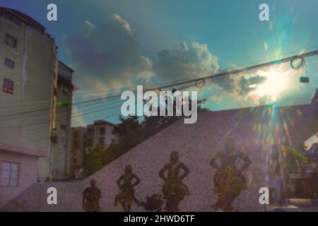 Verschwommenes Bild von Kalkutta, Westbengalen, Indien. Kalkutta Stadtbild, moderne Architektur von Gebäuden, Sonnenstrahlen, die durch Wolken platzen, blauer Himmel im Rücken Stockfoto