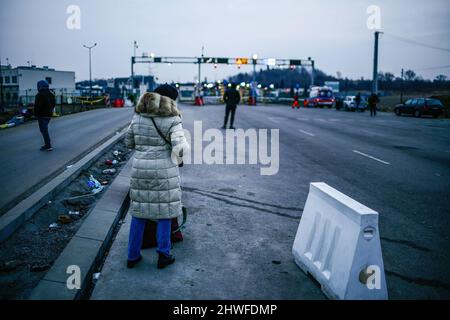 Am Grenzübergang wird eine Frau gesehen, die auf ihre Verwandten wartet. Polnisch-ukrainischer Grenzübergang in Medyka. Seit Beginn der russischen Invasion in der Ukraine sind rund 700.000 Menschen nach Polen geflohen, um dem Krieg zu entkommen. Trotz erheblicher Fehlinformationen und isolierter Vorfälle werden ukrainische Flüchtlinge mit Empathie, Hilfe und Verständnis begrüßt, aber viele humanitäre Experten deuten darauf hin, dass bei einem so großen Zustrom von Menschen in wenigen Wochen eine Krise eintreten könnte. (Foto von Filip Radwanski/SOPA Images/Sipa USA) Stockfoto