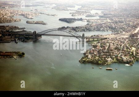 Schräge Luftaufnahme der Sydney Harbour Bridge, Sydney, New South Wales, Australien 1956 - vor dem Bau des Opernhauses auf der Halbinsel links Stockfoto