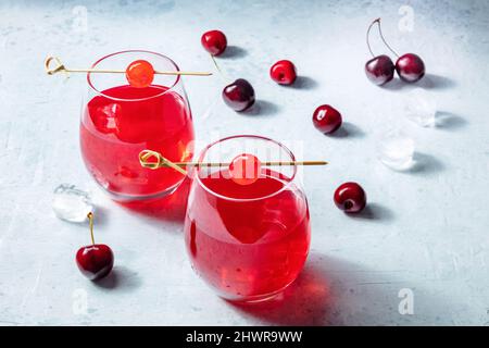 Cocktail Kirschen und Mocktails, ein pulsierendes rotes Getränk mit Eis, kaltes Sommergetränk Stockfoto