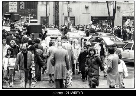 Eine sehr überfüllte Straßenszene zur Weihnachtszeit in Manhattan auf der Fifth Avenue gleich neben dem Rockefeller Center. Ca. 1975. Stockfoto