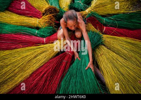 Vietnamesischer alter Handwerker trocknet traditionelle vietnamesische Matten im alten traditionellen Dorf in dinh Yen, dong thap, vietnam, Tradition Künstler Konzept, Stockfoto