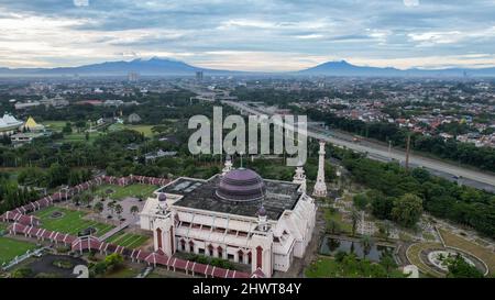 Luftaufnahme der At Tin Grand Mosque, wo diese Moschee die größte Moschee in Indonesien ist, die sich in Ost-Jakarta mit Blick auf die Berge befindet. Jakarta, Stockfoto