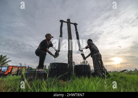 Vietnamesischer Arbeiter Färbet das Gewebe im traditionellen Prozess in Vietnam Stockfoto