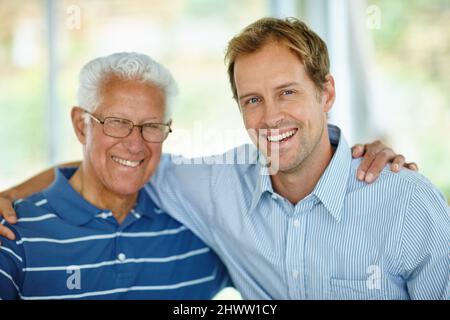 Wie Vater, wie Sohn. Porträt eines Vaters und eines Sohnes, die zusammen sitzen. Stockfoto