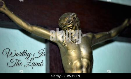 Kruzifix, Jesus am Kreuz mit Text - würdig ist das Lamm. Stockfoto