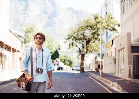 Erkunden Sie die Stadt. Aufnahme eines hübschen jungen Touristen, der sich die Sehenswürdigkeiten ansieht. Stockfoto