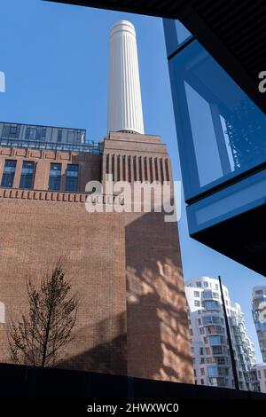 Eine Landschaft mit den restaurierten Schornsteinen und der Ziegelarchitektur des Battersea Power Station in Nine Elms am 7.. März 2022 in London, England. Stockfoto