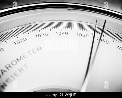 Nahaufnahme der Skala mit dem Zeiger auf der rechten Seite eines analogen manuellen Barometers, monochrom. Stockfoto