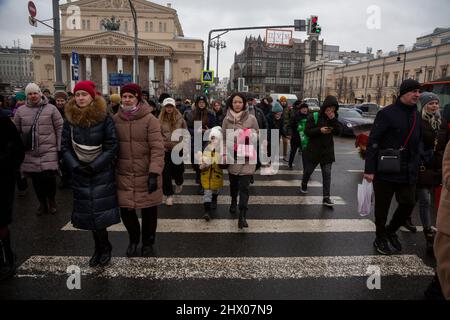 Moskau, Russland. 8.. März, 2022 Menschen überqueren die Straße Theater proezd auf einer Fußgängerüberführung im Zentrum von Moskau, Russland Stockfoto