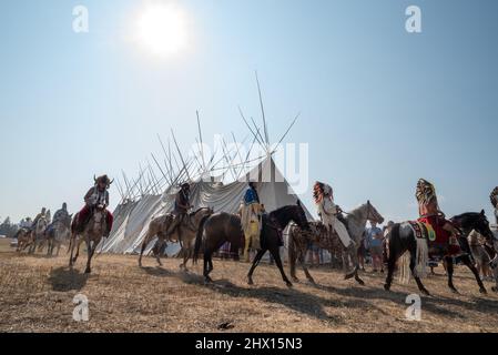 Nez Perce Reiter in einer Prozession um ein Langhaus in am'saaxpa, Wallowa Valley, Oregon. Stockfoto