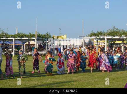 Junge indianische Tänze, die an dem Pow Wow Festival in Kostümen teilnehmen. Stockfoto