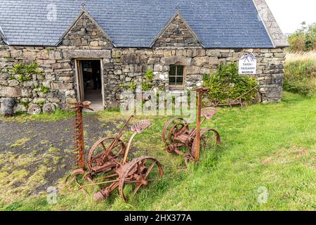 Alte landwirtschaftliche Geräte vor dem Staffin Ecomuseum in der Nähe von Ellishadder an der Nordostküste der Isle of Skye, Highland, Schottland, Großbritannien. Stockfoto