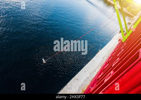 Ropjumping - Springen von der Brücke auf einem elastischen Band zum Fluss. Stockfoto