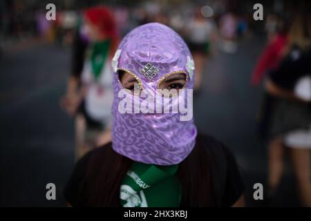 Santiago, Chile. 08. März 2022. Eine Aktivistin trägt während der Demonstration eine Balaclava-Maske. Feministinnen marschieren am 8.. März in Santiago de Chile zu einer Demonstration, die an die sozialen, politischen und wirtschaftlichen Errungenschaften von Frauen erinnert. (Foto von Vanessa Rubilar/SOPA Images/Sipa USA) Quelle: SIPA USA/Alamy Live News Stockfoto