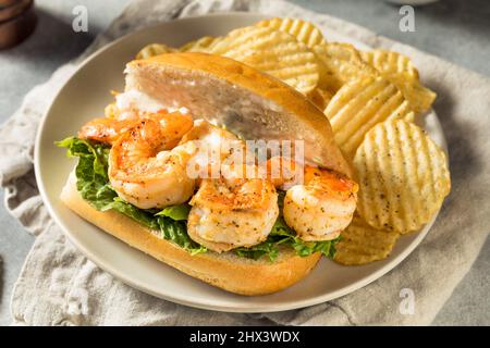 Hausgemachtes Southern Shrimp Po Boy Sandwich mit Kartoffelchips Stockfoto