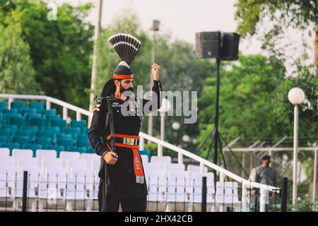 Pakistanische Soldaten in heller Militäruniform auf der Wagah Attari Border Show Stockfoto