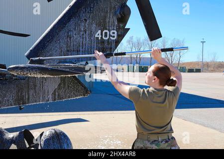 Lincoln, Nebraska, USA. 1. März 2022. Nebraska Army National Guard Spc. Cassidy Mullen, ein Hubschrauber-Mechaniker, der der Golf Company (MEDEVAC) zugewiesen wurde 2-104. General Support Aviation Bataillon, wäscht einen UH-60 Black Hawk in der Army Aviation Support Facility #1 in Lincoln, Nebr., 1. März 2022. Kredit: U.S. Army/ZUMA Press Wire Service/ZUMAPRESS.com/Alamy Live Nachrichten Stockfoto