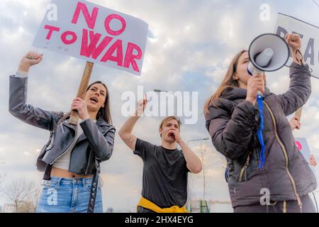 Eine Gruppe junger Menschen protestiert draußen auf der Straße Stockfoto