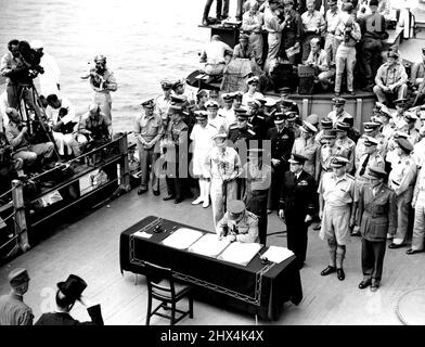 Kapitulation in der Bucht von Tokio -- General Sir Thomas Blamey unterzeichnet im Namen Australiens das Kapitulationsdokument an Bord der U.S.S. Missouri in der Bucht von Tokio in Anwesenheit der Unterzeichner der Alliierten und der japanischen Vertreter (im Vordergrund links). 15. August 1945. (Foto von Australian Official Photo). Stockfoto