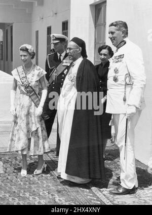 'Die Königin ist zu Hause' -- mit König Idris von Libyen, in seinem Palast in Tobruk, erscheinen Ihre Majestät die Königin und der Herzog von Edinburgh auf dem Balkon mit Blick auf den Hafen. Dort lag an ihrem Morgen die königliche Yacht 'Britannia' mit Prinz Charles und Prinzessin Anne an Bord und wartete auf die glückliche Wiedervereinigung und wünsche ihren Eltern nach den langen Monaten der Trennung. 1. Juni 1954. Stockfoto