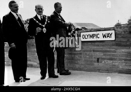 „Olympic Way“ wurde in Readiness for the Games eröffnet -- Lord Burghley (links) mit Ratsmitglied H. Sirkett, Bürgermeister von Wembley, schaut zu, wie Alfred Barnes das Namensschild des neuen „Olympic Way“ enthüllt. Die offizielle Eröffnung der neuen Straße, die von der Wembley Park Station zum Empire Stadium gebaut wurde, wurde vom Verkehrsminister Alfred Barnes durchgeführt. Die Straße, die „Olympischer Weg“ genannt wird, wird die Bewegung des Verkehrs und der Besucher der Olympischen Spiele erheblich erleichtern. 7. Juli 1948. (Foto von Sport & General Press Agency Limited). Stockfoto