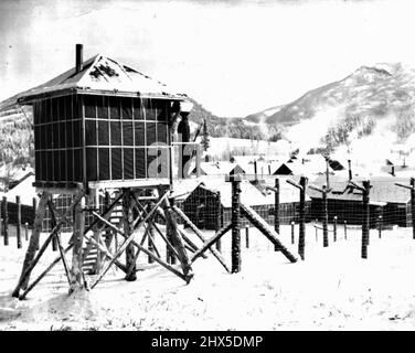 Where Canada Keeps Alien Enemies : von einem der Wachtürme aus blickt eine Wache über das Kananaskis Internment Camp, das hoch oben in den kanadischen Rockies westlich von Calgary liegt, einem von zwei Camps, in denen das britische Dominion ihre Alien Enemies interniert. 10. März 1940. (Foto von Associated Press Photo). Stockfoto