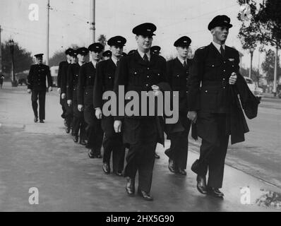 Neue Polizei auf dem Weg zum Polizeihauptquartier, wo sie heute ihren Dienst antraten, marschieren neue Polizisten in der neuen Polizeiuniform unter dem kritischen Auge ihres Bohrlehrers (hinten im Trupp) über die Princes Bridge. 28. April 1947. Stockfoto