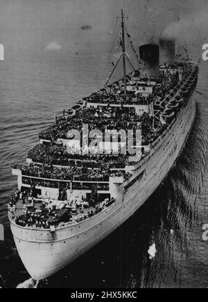 US-Soldaten kehren auf der Queen Elizabeth nach Hause zurück - mit ihren Decks voller 13.113 amerikanischer Kampfmänner dampft die Queen Elizabeth, der größte Ozeandampfer der Welt, am 29. Juni 1945 die New York Bay an. Zu den Heimaufziehungstruppen an Bord gehören 13.658 Männer der Achten US-Armee-Luftwaffe und allgemeine Krankenhauseinheiten sowie 1.200 Navy-Männer und 442 Army Nurses. Alle kehren aus dem europäischen Kriegstheater zurück, und viele werden bald im Pazifik Dienst sehen. Das 85.000-Tonnen-Truppenschiff unternahm 1940 ihre erste Reise über den von U-Booten befallenen Atlantik in Larch. Dies ist ihr erster offizieller Besuch Stockfoto