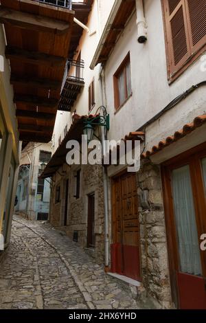 Traditionelle Steinhäuser um leeres Pflastersteinpflaster herum. Historisches Dorf Dimitsana enge Gassen ohne Menschenmassen, in Arcadia Peloponnes. Stockfoto