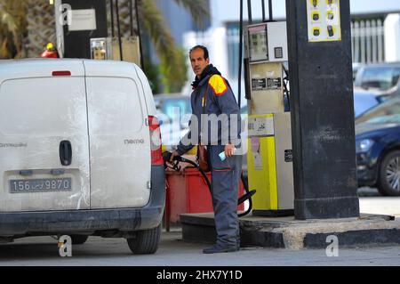 Am 9. März 2022 füllt ein Mann den Tank eines Fahrzeugs an einer Agil-Tankstelle in Tunis, Tunesien. Das Ministerium für Industrie, Bergbau und Energie bestätigte am 1. März, dass es die Verkaufspreise für Kraftstoffe an der Pumpe neu einstellen werde, während der Preis für ein Barrel Öl infolge des russischen Krieges in der Ukraine weiter steigt. In der vergangenen Woche schwankte der Preis von Brent zwischen $98 (88 €) und $104 (93 €). Aber diese Erklärung allein bringt nicht die Situation in Tunesien auf den Punkt. Dies ist der zweite Anstieg innerhalb eines Monats, ein äußerst seltenes Ereignis in Tunesien, das den Wunsch der Regierung bestätigt Stockfoto