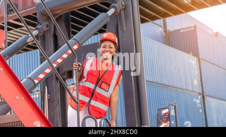 Weibliche Vorarbeiter bleiben auf Heben Container Fracht Gabelstapler prüfen oder überprüfen und kontrollieren Gabelstapler Konzept Service und Transport logistic. Stockfoto