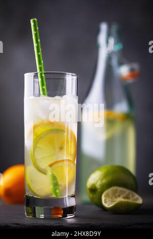 Glas Wasser mit Zitrone und Limette auf dem Tisch, Nahaufnahme Stockfoto