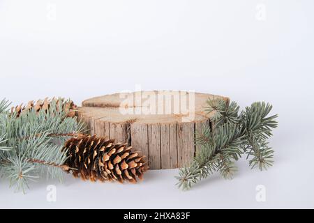 Holzständer für Waren. Stand-up. Neujahrskarte für Werbung. Baumstumpf Werbevorlage. Eine Scheibe Holz und Zapfen und Fichtenzweige. Stockfoto