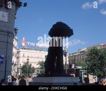 ESTATUA DEL OSO Y EL MADROÑO AL FONDO EL EDIFICIO CON LA PUBLICIDAD DEL JEREZ TIO PEPE - FOTO AÑOS 90. AUTOR: NAVARRO SANTAFE ANTONIO. Lage: SONNENTOR. MADRID. SPANIEN. Stockfoto