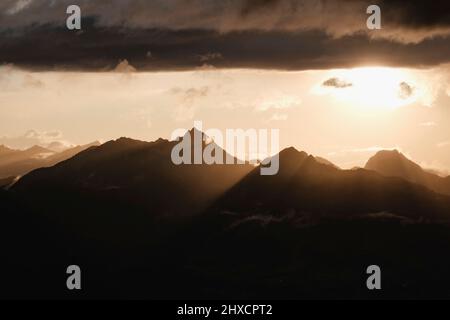 Geschichtete Berge bei Sonnenschein nach Niederschlägen mit weichen Wolken Stockfoto