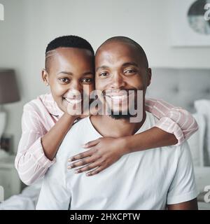 Die warme Umarmung eines glücklichen Zuhauses. Porträt eines liebevollen jungen Paares, das einen liebevollen Moment im Schlafzimmer zu Hause teilt. Stockfoto