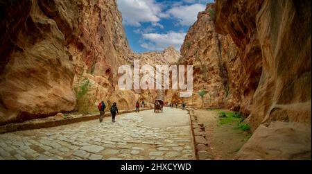 Touristen, die Petra in Jordanien besuchen, wandern oder werden von Beduinenkarren unterstützt 25. Februar 2020 Stockfoto