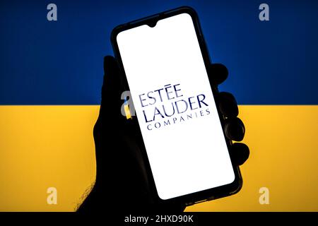 Spanien. 11. März 2022. In dieser Abbildung ist ein Logo von Estee Lauder Companies zu sehen, das auf einem Smartphone mit einer ukrainischen Flagge im Hintergrund abgebildet ist. (Foto von Thiago Prudencio/SOPA Images/Sipa USA) Quelle: SIPA USA/Alamy Live News Stockfoto