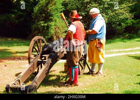 Zwei Erwachsene Männer demonstrieren, wie sie in Jamestown, Virginia, einen Kanon aus der Kolonialzeit feuerten Stockfoto