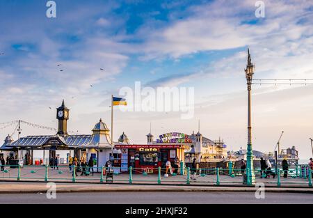 In Brighton, England, geht das Leben normal weiter, aber die ukrainische Flagge symbolisiert den Kampf, der vor sich geht, Brighton Palace Pier, in Brighton, East Sussex Stockfoto