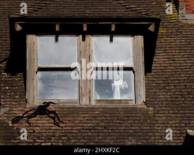 Geisterhafte Figur im Fenster eines verwüstenden Hauses, das lokal als Spukhaus, Westward Ho!, Devon, Großbritannien, bekannt ist Stockfoto